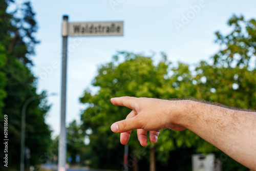 Navigating the City-up of a Man Pointing to a Street Sign