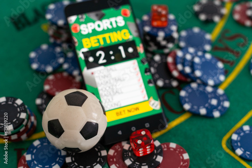 online casino concept, playing cards, dice chips and smartphone with copyspace on the green table. view from above. banner template layout mockup for online casinos and gambling.