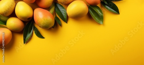 Creative food summer mangos fruits banner  - Top view of many fresh ripe mango and tropical leaves, isolated on yellow background texture (Generative Ai) photo