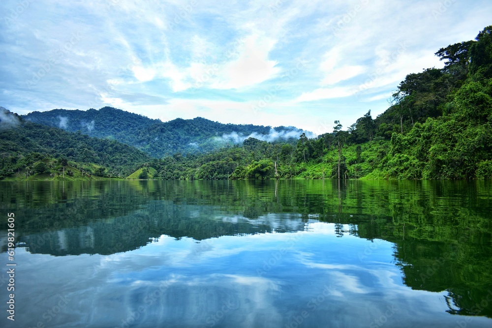 Reflections in the jungle between water and mountains