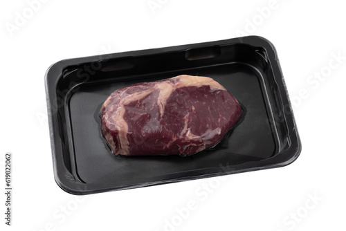 Vacuum-packed steak on a white background. A piece of vacuum-packed beef close-up on a white background.