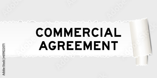 Ripped gray paper background that have word commercial agreement under torn part