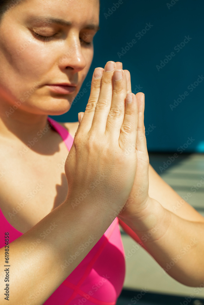 a close up of a young woman practicing yoga, exercising indoors. Calmness and relax, female happiness. a close up of a young woman practicing yoga, exercising indoors. Calmness and relax, female happiness.