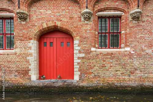 Bruges, Belgium. Historic center of the city. Door and window with brick wall of medieval house on Rozenhoedkaai canal. West Flanders Province, Belgium. Cityscape of Bruges (Brugge). © Stefan Lambauer
