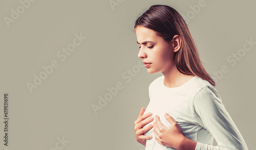 Woman having heart attack. Heart attack concept. Girl feeling heart pain and holding her chest. Healthcare and medical concept