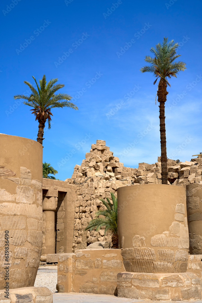 Two palm trees among the ruins of the Karnak Temple, Luxor, Egypt