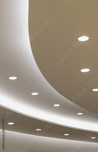 Obraz na płótnie Ceiling with Curved LED lights. Circle cove light decoration, recessed ceiling luminaires. Space for text, Selective focus. w salonie