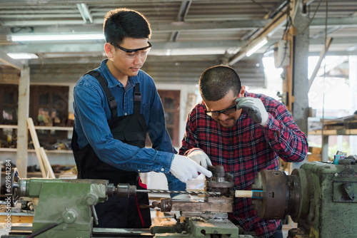 Two Asian carpenters consulting while working