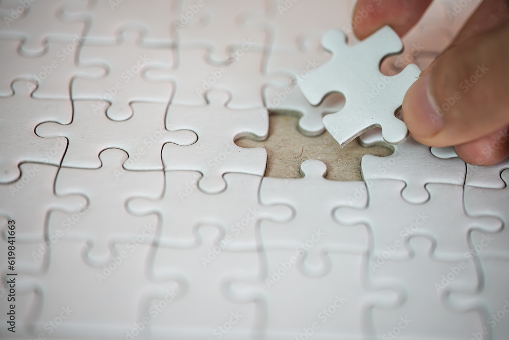 Fototapeta premium Business Solution concept White jigsaw puzzle pattern background finding missing piece for business success concept or placing last piece of jigsaw puzzle for solve problem development Strategy Plan 