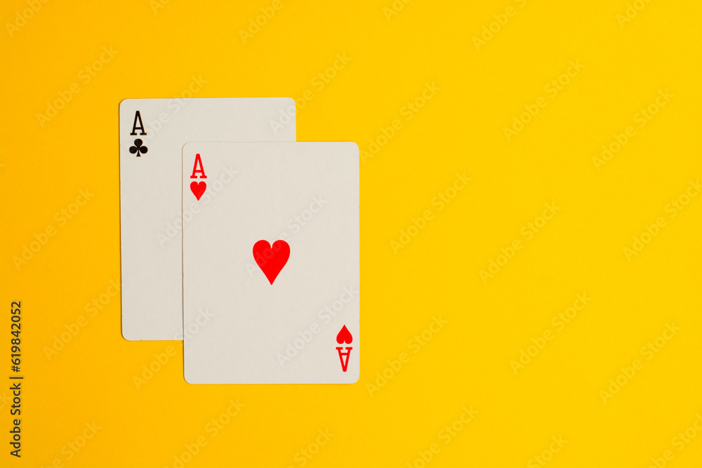 Two Ace playing cards on yellow background with copy space Two Ace playing cards on yellow background with copy space