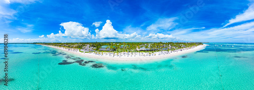 Aerial panorama of the tropical island and beach with white sand and turquoise water of the Caribbean Sea. Top places for summer vacations in all Inclusive resorts and hotels in Punta Cana