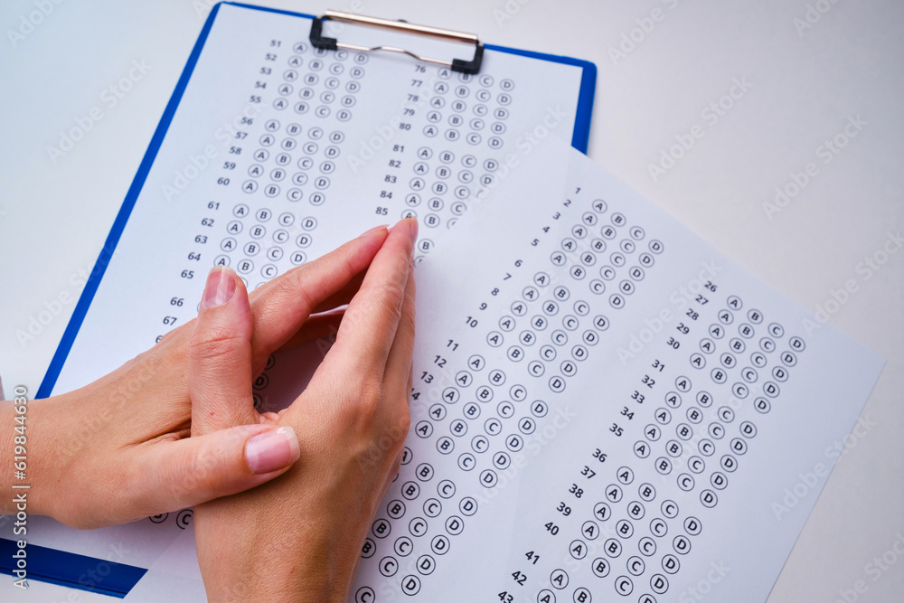 Obraz premium Admission test. Examination form. Choosing the correct answer. A sheet of paper with a test task. School exam. University quiz. Right or wrong option. Student to study. Elementary school question