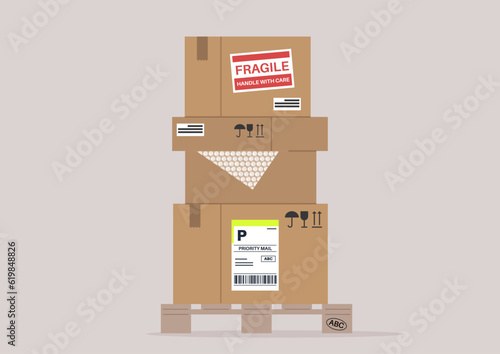 A stack of cardboard boxes with different labels on a wooden palette