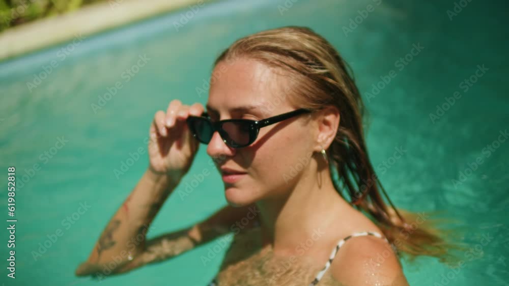 Active woman, girl relaxing in swimming pool, happy young woman swims in blue water, Bali villa, tropical vacation, holiday on island hotel resort. Active woman, girl relaxing in swimming pool, happy young woman swims in blue water, Bali villa, tropical vacation, holiday on island hotel resort.
