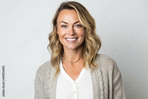 Portrait of happy woman smiling at camera over white background. Looking at camera