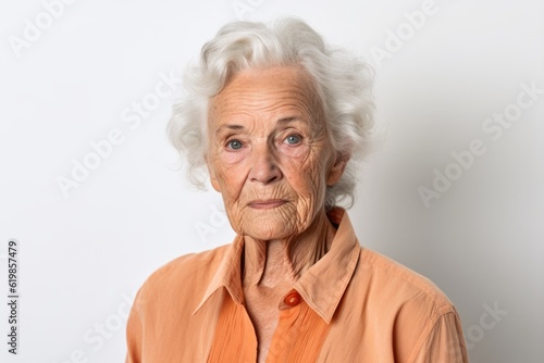 Portrait of a senior woman looking at the camera on a white background