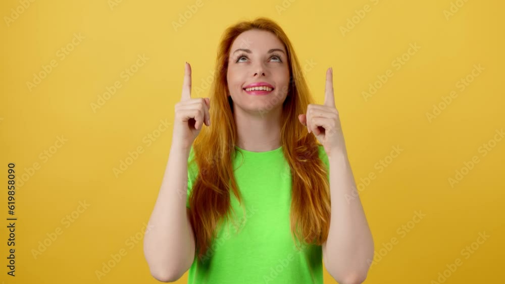 Woman and pointing at mockup workspace for advert, marketing, promotion or text. Fashionable model happy smiling showing mock up for advertisement, news deal of offer in studio on yellow background Woman and pointing at mockup workspace for advert, marketing, promotion or text. Fashionable model happy smiling showing mock up for advertisement, news deal of offer in studio on yellow background