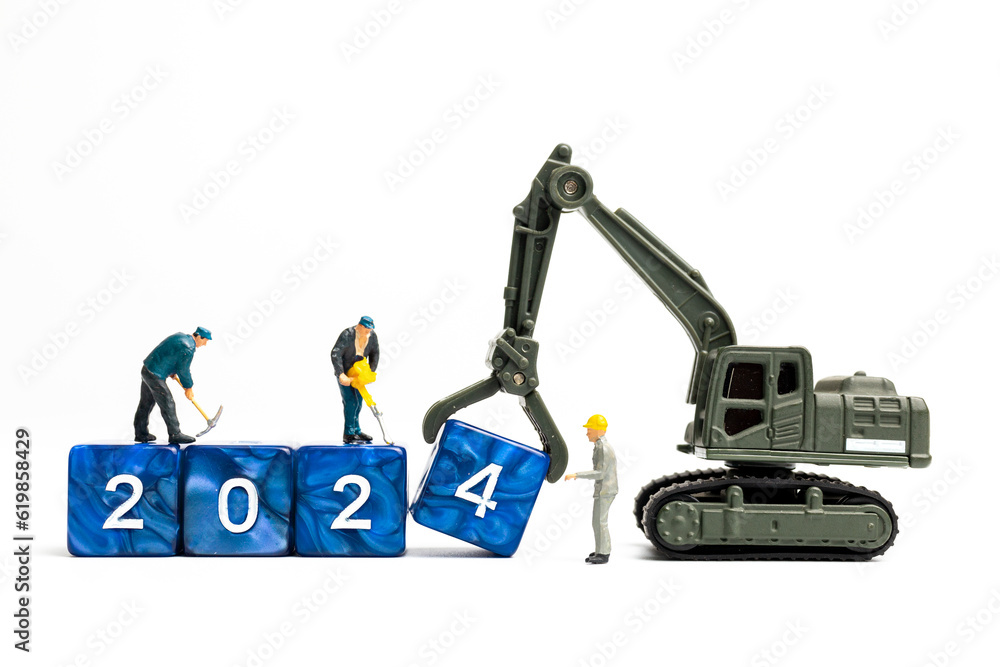 Miniature people , Worker team flips a block with the number 2024, On a white background Miniature people , Worker team flips a block with the number 2024, On a white background