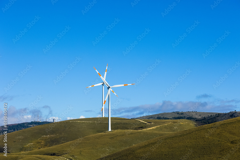 a wind farm full of turbines in the Italian mountains. The green economy and technology are the only solution to protect the planet from climate change and global warmi a wind farm full of turbines in the Italian mountains. The green economy and technology are the only solution to protect the planet from climate change and global warmi