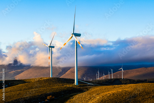a wind farm full of turbines in the Italian mountains. The green economy and technology are the only solution to protect the planet from climate change and global warmi
