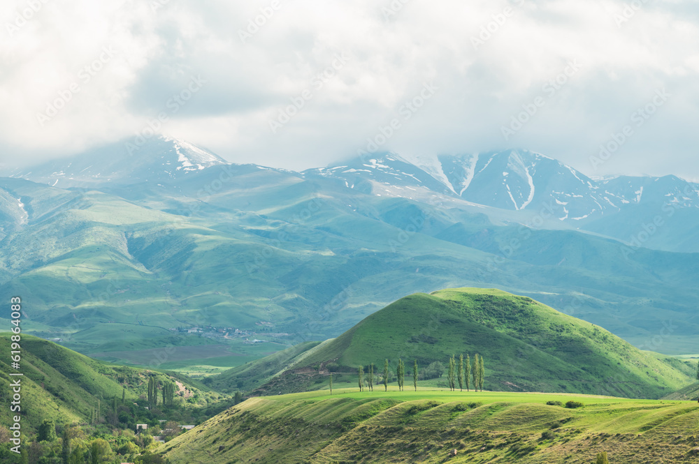 Obraz premium Cloudy sky over green hills. Summer in the mountains.
