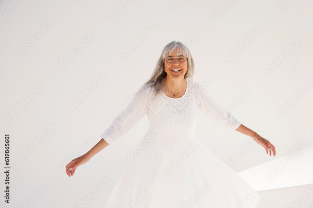 Naklejka premium Photograph of a happy senior woman on a white background. Ayurvedic Marma demonstrated by a senior practitioner on a female client. Photography on a white background.