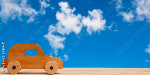 Miniature wooden car with neutral background. Electric car, sustainable mobility. Circulation of vehicles with low environmental impact. Current car. AI generative. © DavidArt