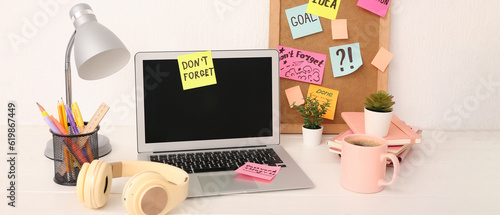 Laptop with sticky notes, h...