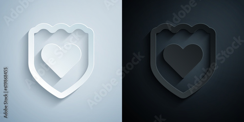 Paper cut Immune system icon isolated on grey and black background. Medical shield. Paper art style. Vector