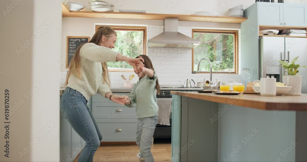 Dance, happy and mother with daughter in kitchen for celebration, love and energy. Music, happiness and trust with woman and young girl dancing in family home for support, learning and holding hands Dance, happy and mother with daughter in kitchen for celebration, love and energy. Music, happiness and trust with woman and young girl dancing in family home for support, learning and holding hands