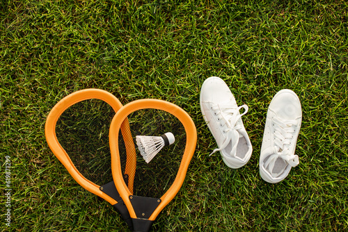 Badminton. Tennis. Tennis rocket. Shuttlecock for badminton. Sport lifestyle concept. Outdoor sports. White sneakers.