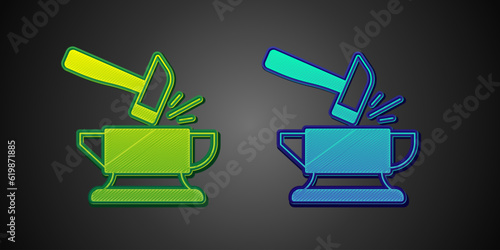 Green and blue Blacksmith anvil tool and hammer icon isolated on black background. Metal forging. Forge tool. Vector