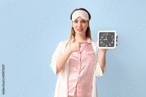 Young woman in pajamas poin...