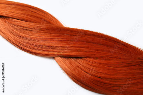 Braided ginger hair on white background, closeup