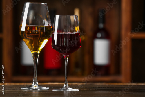 Glasses of exquisite wine on table in cellar