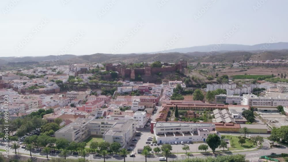 Aerial panoramic view of Algarve countryside medieval city of Silves, and its castle on the hill top, a famous destination Region, in South Portugal. Aerial panoramic view of Algarve countryside medieval city of Silves, and its castle on the hill top, a famous destination Region, in South Portugal.