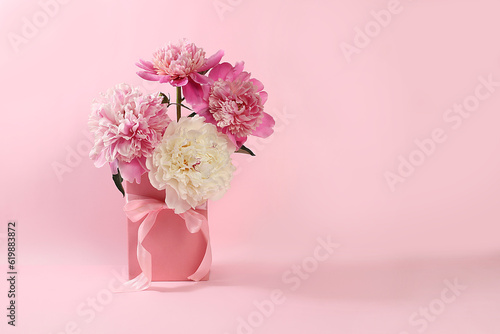 Beautiful peonies flowers in festive box on light background,minimal holiday concept with flowers,greeting card for wedding,birthday,mother's day,selective focus