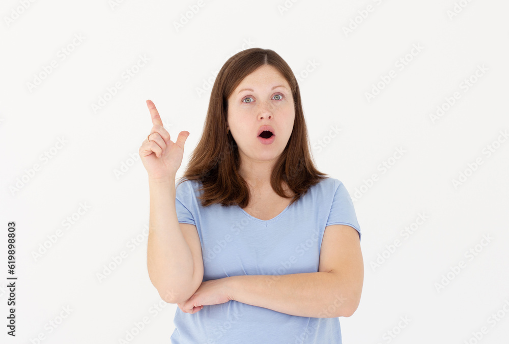 Close-up portrait of charming young pregnant woman in blue t-shirt pointing with finger, looking at camera, isolated on white background Close-up portrait of charming young pregnant woman in blue t-shirt pointing with finger, looking at camera, isolated on white background