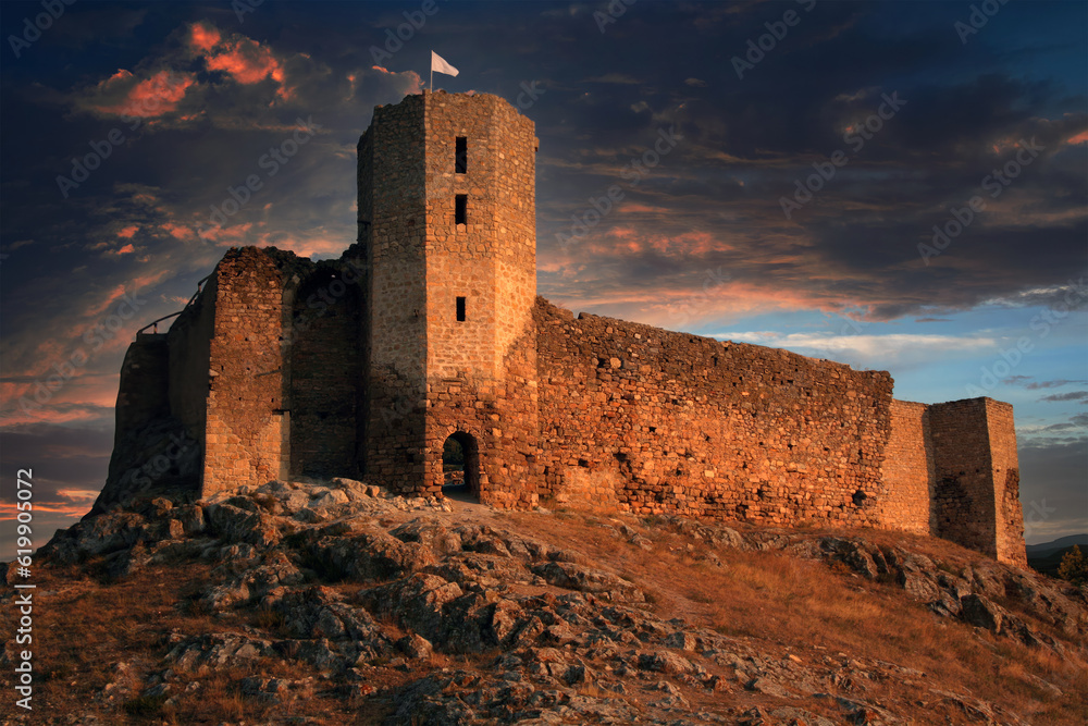 Fortress on the mountain with flag at twilight. Biblical concept of the tower of escape.