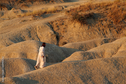 Jesus going alone up on a hill in a desert. Biblical concept.