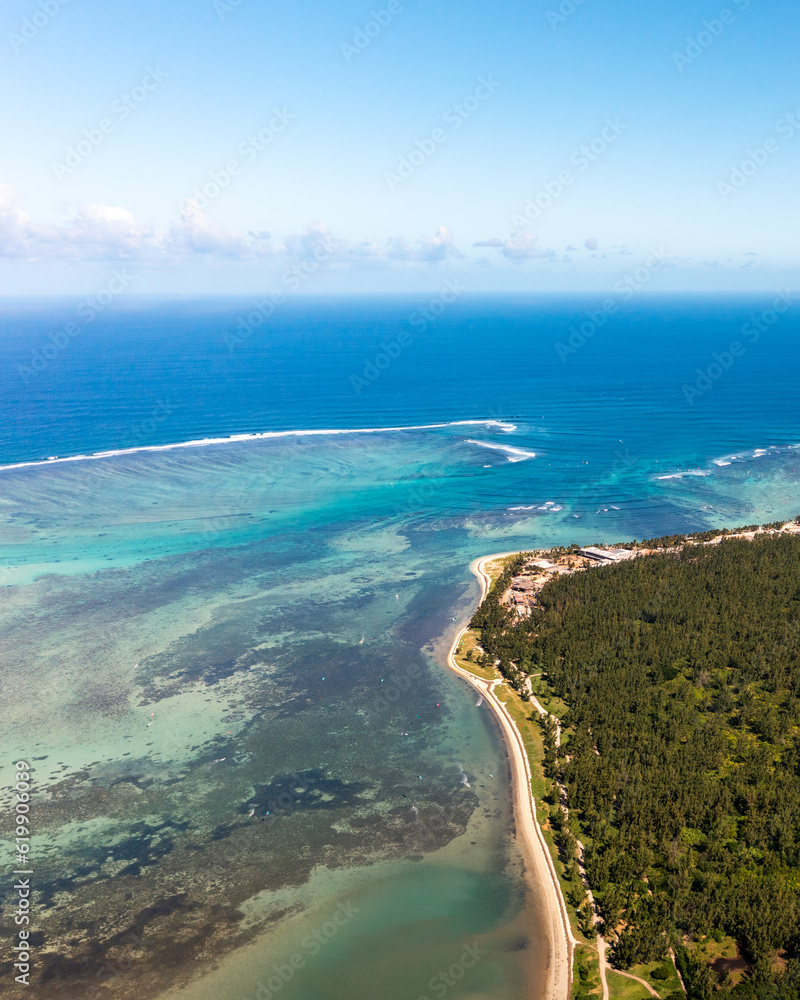Wind surfers, turquoise ocean, beach and coral reefs from high angle view in Le Morne beach, Mauritius