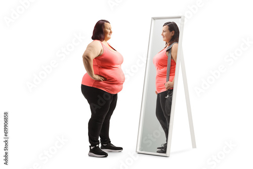 Obraz na plátne Overweight woman looking at a slimmer version of herself in the mirror
