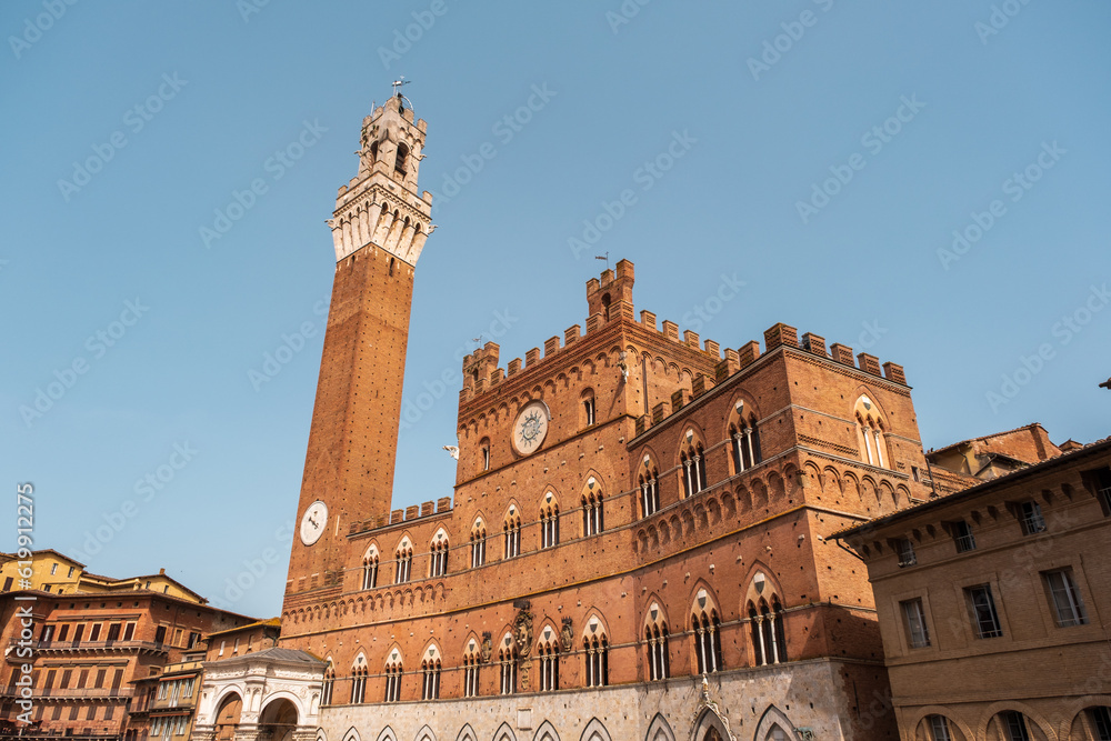 The Palazzo Pubblico in Piazza del Campo, the central square of Siena, Tuscany, Italy.