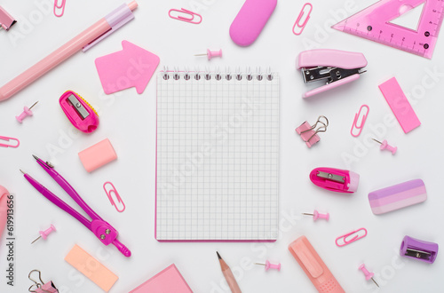 Pink school stationery on color backgroung, top view
