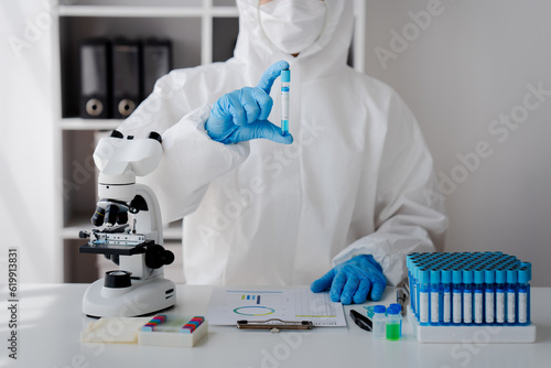Hand of doctor or research scientist taking a test tube to check data in laboratory biotechnology specialist Ambitious new generation Works with advanced devices