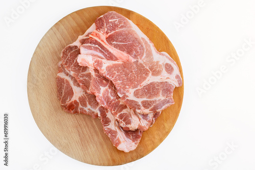 On white isolated background, there are large pieces of raw fresh meat marbling pork.