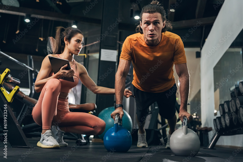 Obraz premium Workout, Fitness workout in gym with trainer assisted in training, Fitness concept, Fit asian woman, Young white man and asian girl exercising in the gym.