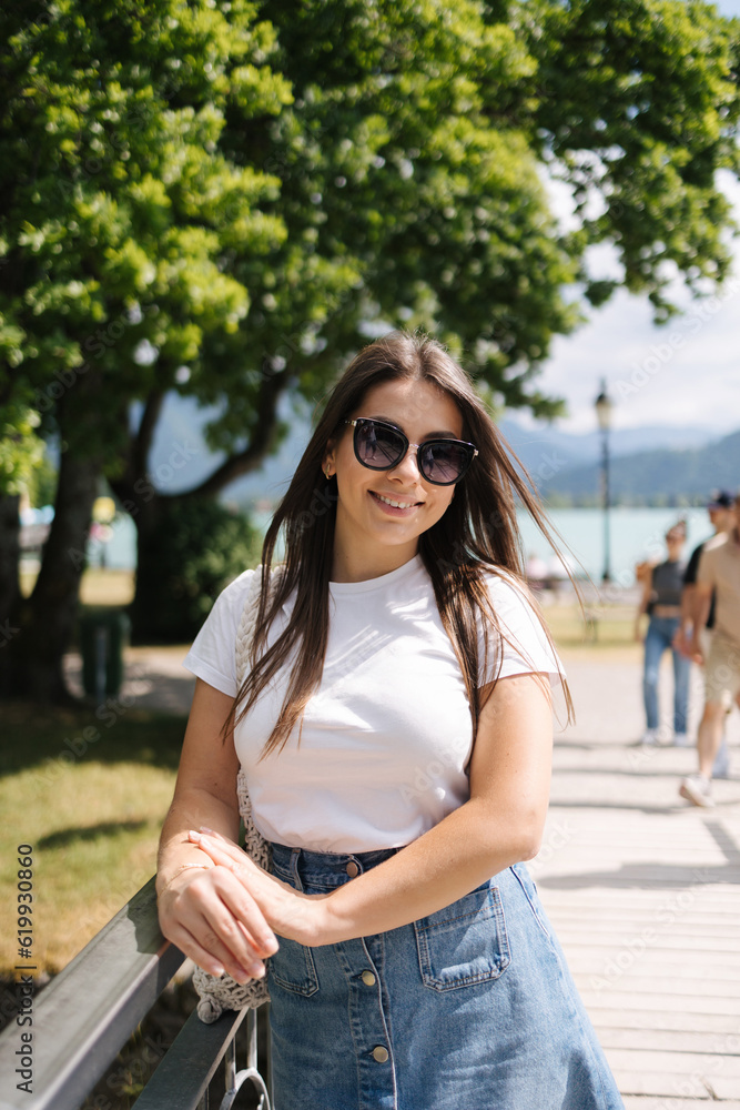 Portrait of pretty woman in beautiful place near the big lake. Attractive young woman 