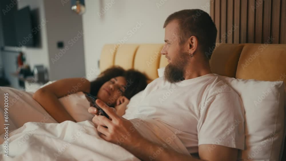 Young husband hiding secrets from his wife, using dating application, cheating Young husband hiding secrets from his wife, using dating application, cheating