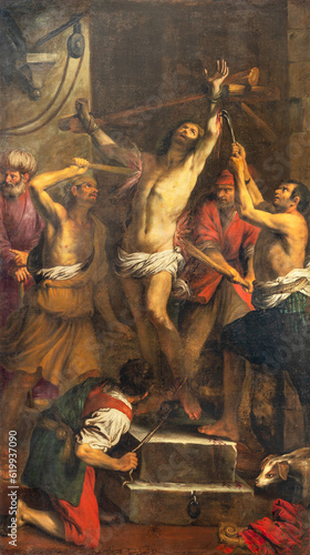 GENOVA, ITALY - MARCH 6, 2023: The painitng of Martyrdom of St. Clement in the church Basilica della Santissima Annunziata del Vastato by Giovanni Battista Carlone (1603 - 1684).